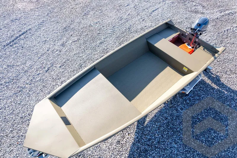 Slide: The Image of 2026 G3 Gator Tough 1548 VBW boat on gravel, featuring a compact design and outboard motor. - 40