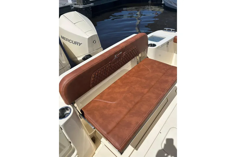 Slide: The Image of 2025 Scout 277 LXF boat with brown leather seating and Mercury engine. - 15