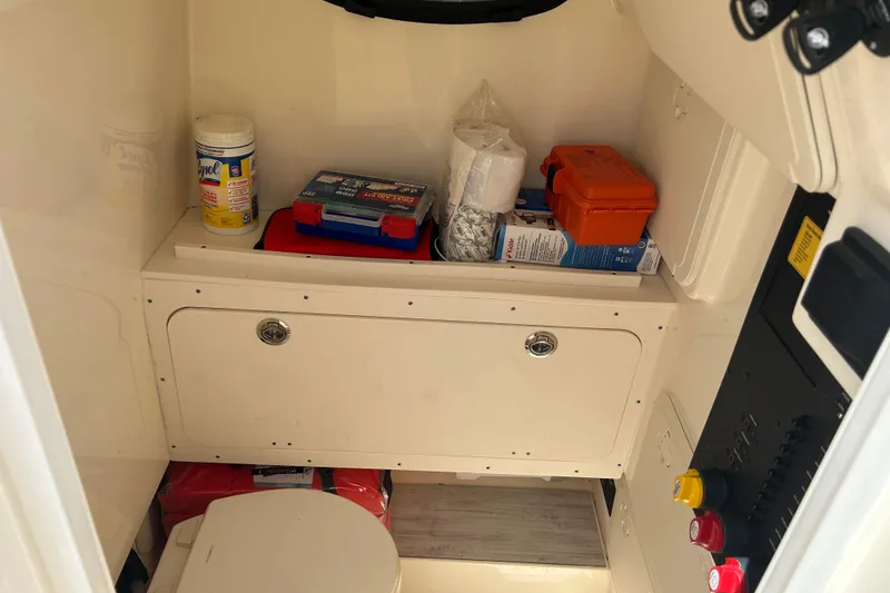 Slide: The Image of Interior of 2025 Scout 277 LXF boat with storage and cleaning supplies. - 30