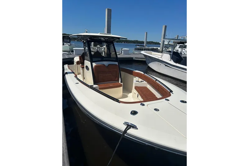 Slide: The Image of 2025 Scout 277 LXF boat docked, featuring sleek design and luxurious seating. - 34