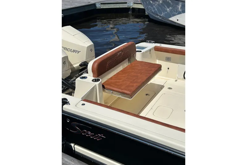 Slide: The Image of 2025 Scout 277 LXF boat interior with brown leather seating and Mercury engine. - 35