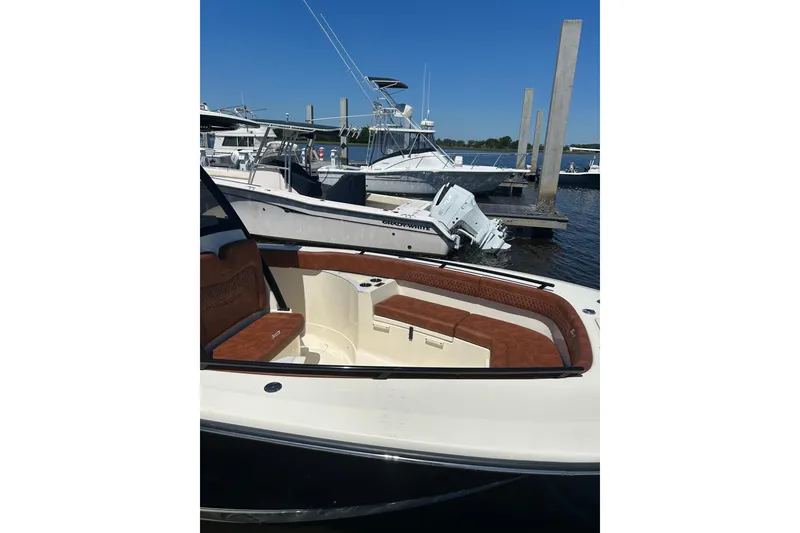 Slide: The Image of 2025 Scout 277 LXF boat docked, featuring luxurious seating and sleek design. - 36