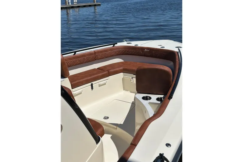 Slide: The Image of 2025 Scout 277 LXF boat interior with luxurious brown seating and cup holders. - 42