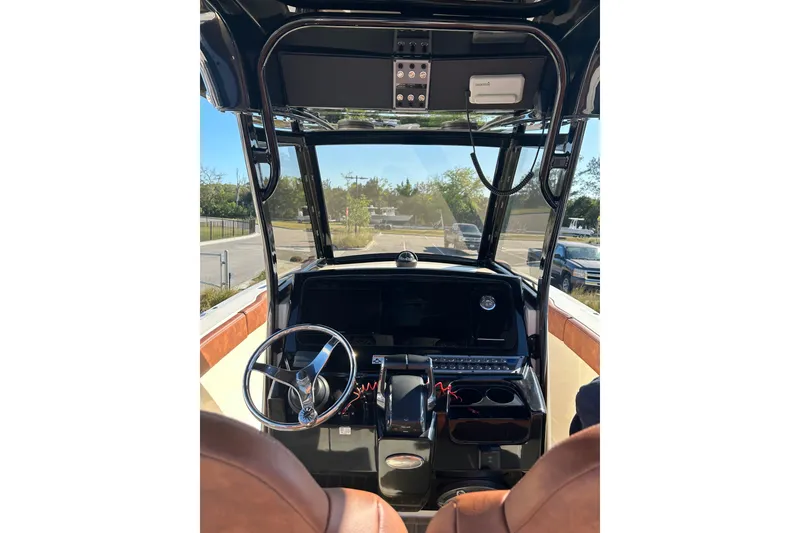 Slide: The Image of Interior view of 2025 Scout 277 LXF boat cockpit with steering wheel and controls. - 51