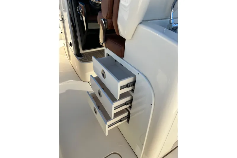 Slide: The Image of 2025 Scout 277 LXF boat interior with open storage drawers. - 57