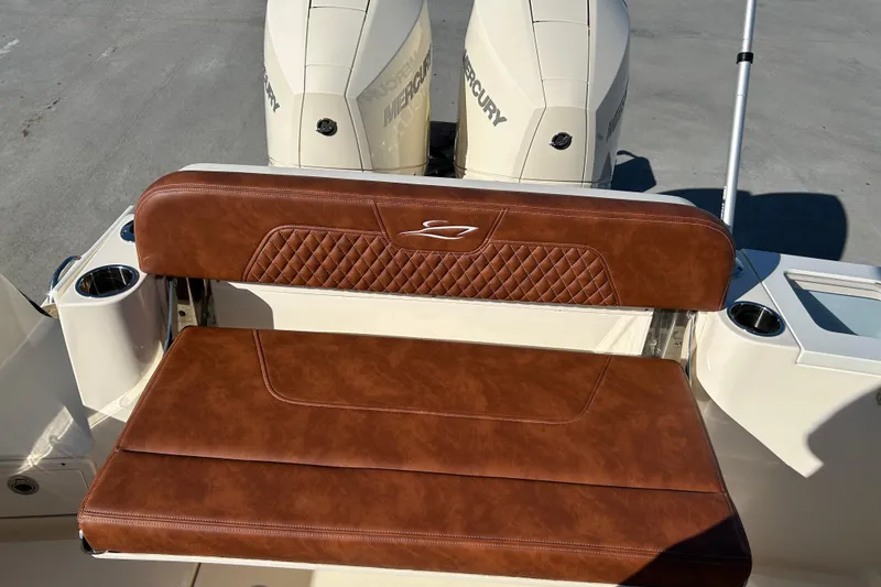Slide: The Image of 2025 Scout 277 LXF boat with brown leather seating and dual Mercury engines. - 58