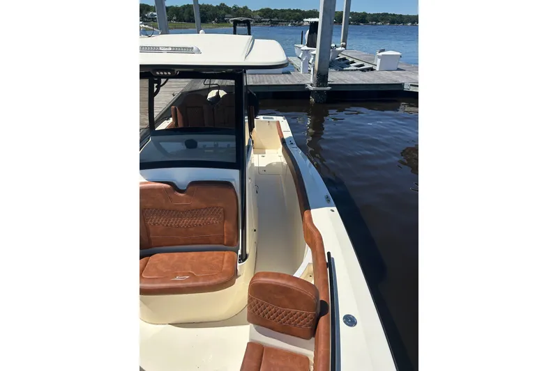 Slide: The Image of 2025 Scout 277 LXF boat with luxurious seating docked by the water. - 8