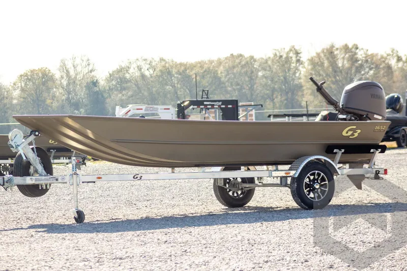 The Image of 2026 G3 Gator Tough 1652 VBW boat on trailer, parked outdoors. - 1