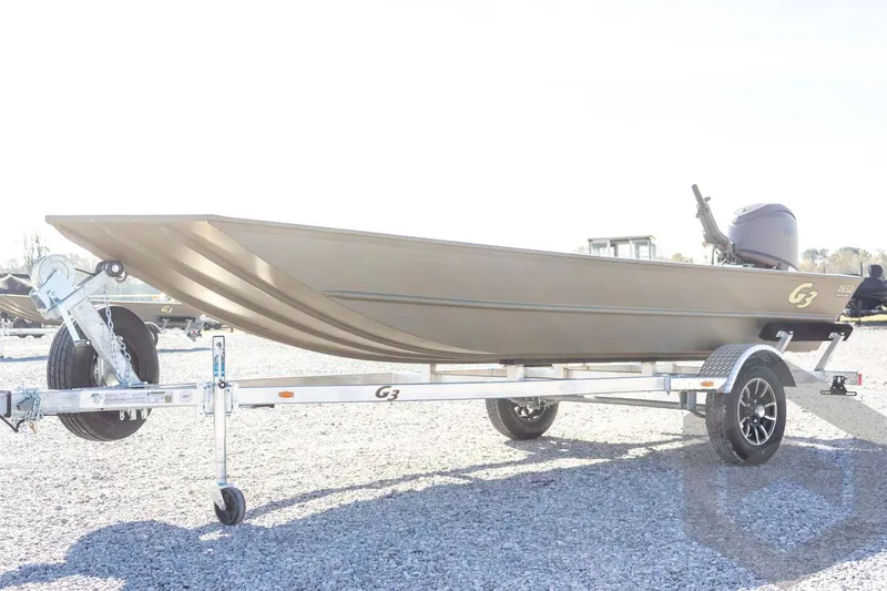 Slide: The Image of 2026 G3 Gator Tough 1652 VBW boat on trailer, displayed outdoors. - 11
