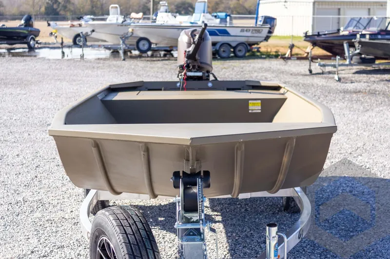 Slide: The Image of 2026 G3 Gator Tough 1652 VBW boat on trailer in outdoor lot. - 12