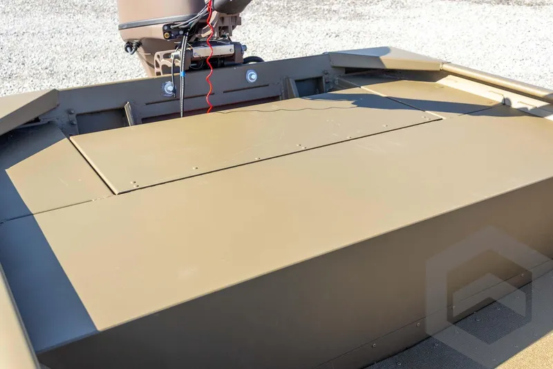 Slide: The Image of 2026 G3 Gator Tough 1652 VBW boat, rear view with motor, on gravel surface. - 24