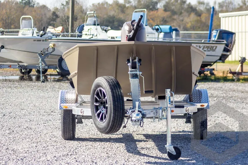 Slide: The Image of 2026 G3 Gator Tough 1652 VBW boat on trailer in outdoor lot. - 6