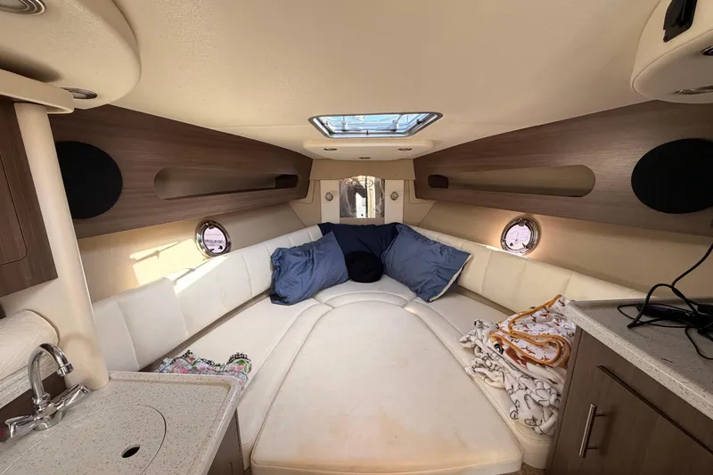 Slide: The Image of 2019 Rinker EX 290 cabin interior with cozy seating and modern amenities. - 13