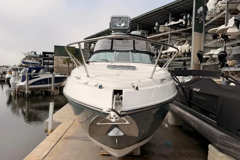 Slide: The Image of 2019 Rinker EX 290 boat docked at marina, surrounded by other vessels. - 3