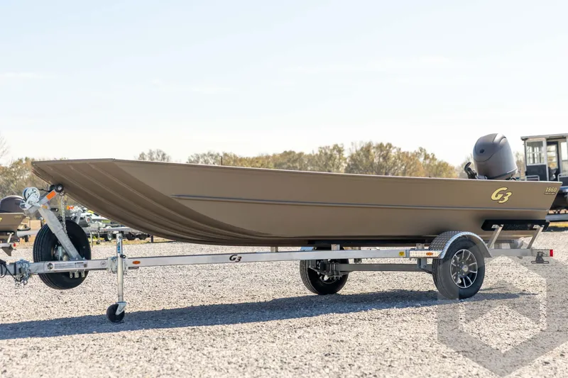 The Image of 2026 G3 Gator Tough 1860 VBW boat on trailer, parked outdoors. - 1