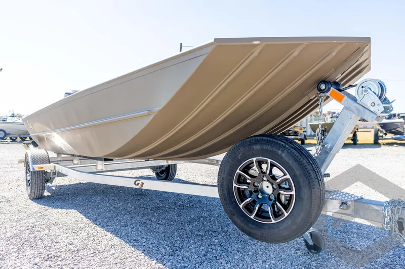Slide: The Image of 2026 G3 Gator Tough 1860 VBW boat on trailer, displayed outdoors. - 12