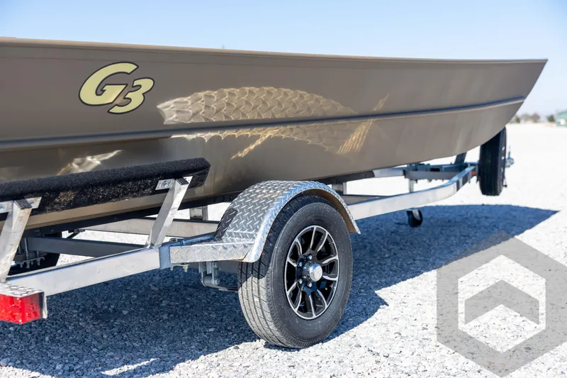 Slide: The Image of 2026 G3 Gator Tough 1860 VBW boat on trailer, side view, outdoors. - 15