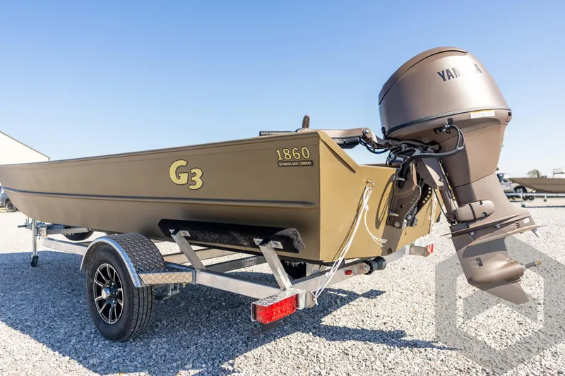 Slide: The Image of 2026 G3 Gator Tough 1860 VBW boat with Yamaha motor on trailer, parked on gravel. - 27