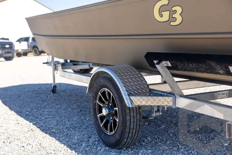 Slide: The Image of 2026 G3 Gator Tough 1860 VBW boat on trailer, parked on gravel. - 29