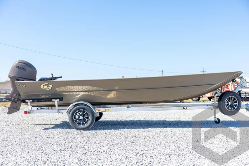 Slide: The Image of 2026 G3 Gator Tough 1860 VBW boat on trailer, featuring Yamaha engine, parked on gravel. - 4