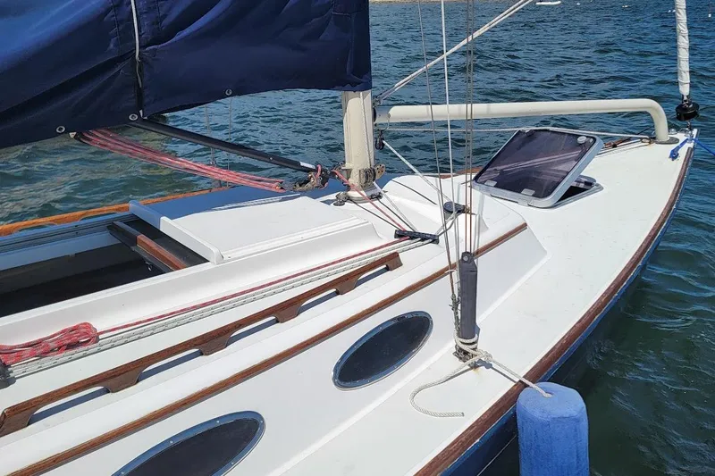 Slide: The Image of 2002 Alerion 28 Express sailboat on water, featuring sleek deck and rigging. - 17