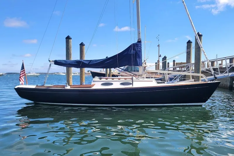 Slide: The Image of 2002 Alerion 28 Express sailboat docked in a marina under a clear blue sky. - 18