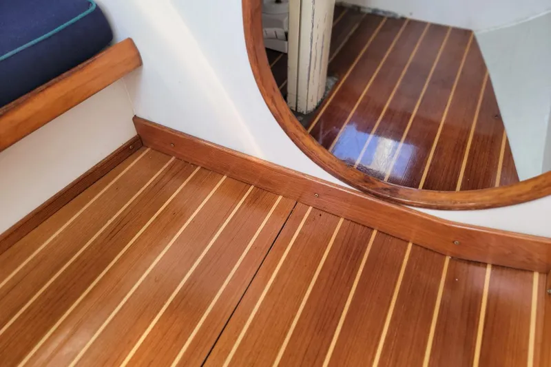 Slide: The Image of Polished wooden interior of 2002 Alerion 28 Express boat, featuring striped flooring. - 3
