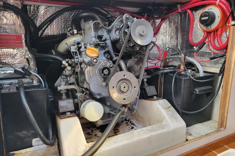 Slide: The Image of Engine compartment of a 2002 Alerion 28 Express sailboat, showing mechanical components and wiring. - 5