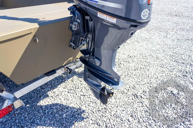 Slide: The Image of 2026 G3 Gator Tough 1652 VBW boat with outboard motor on gravel surface. - 21