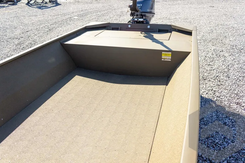 Slide: The Image of 2026 G3 Gator Tough 1652 VBW boat interior with motor, on gravel surface. - 25