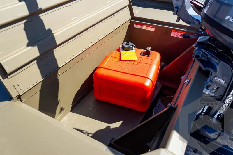 Slide: The Image of 2026 G3 Gator Tough 1652 VBW boat with red gasoline tank in storage area. - 29