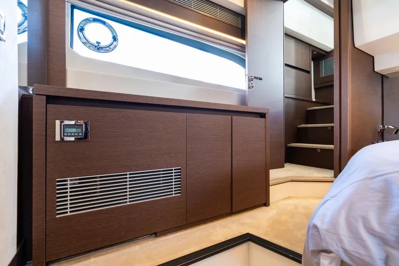 Slide: The Image of Luxurious interior of 2022 Prestige 520 yacht with modern wood finish and elegant staircase. - 12