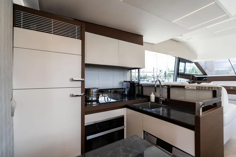 Slide: The Image of Modern kitchen interior on 2022 Prestige 520 yacht, featuring sleek cabinetry and appliances. - 19