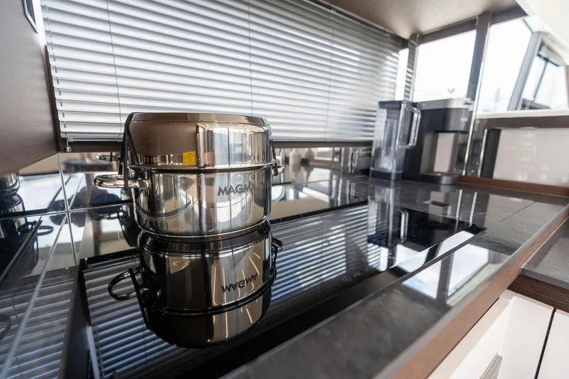 Slide: The Image of Modern kitchen in 2022 Prestige 520 yacht with sleek stovetop and cookware. - 23