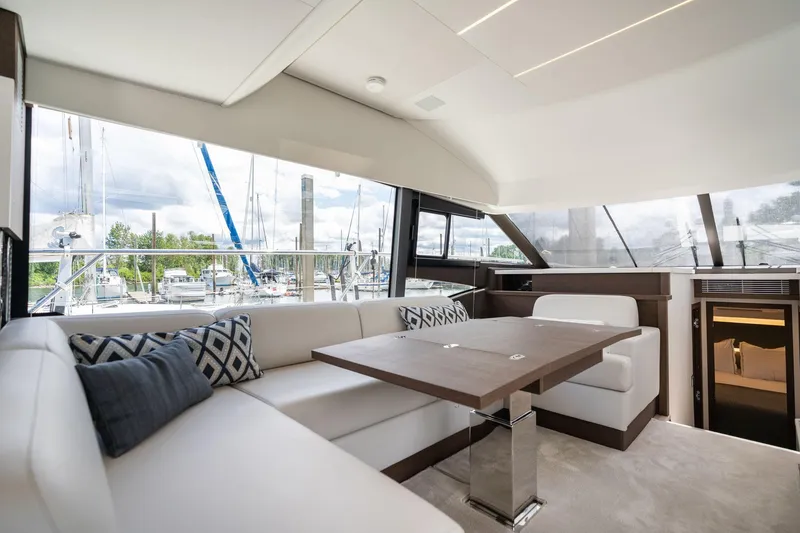 Slide: The Image of Luxurious interior of 2022 Prestige 520 yacht with elegant seating and marina view. - 25