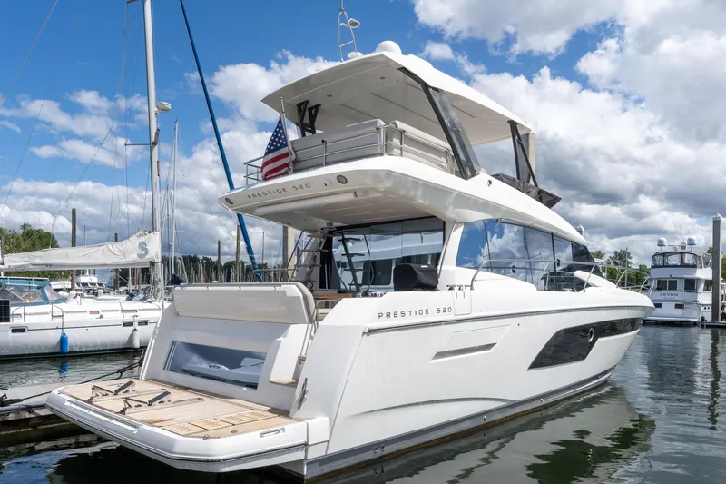 Slide: The Image of Luxury 2022 Prestige 520 yacht docked at marina under blue sky. - 3