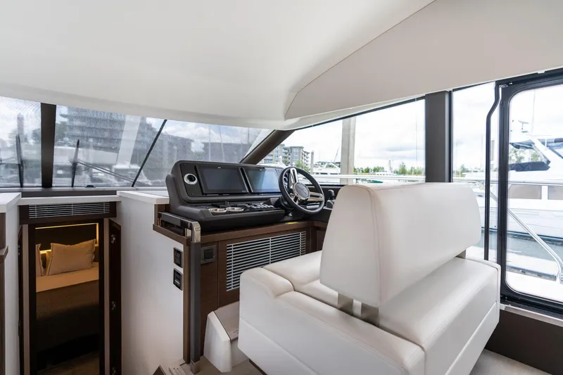 Slide: The Image of Interior of 2022 Prestige 520 yacht with helm station and cabin entrance. - 30