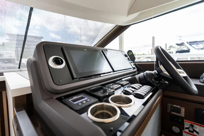 Slide: The Image of Helm of 2022 Prestige 520 yacht with modern controls and navigation screens. - 32