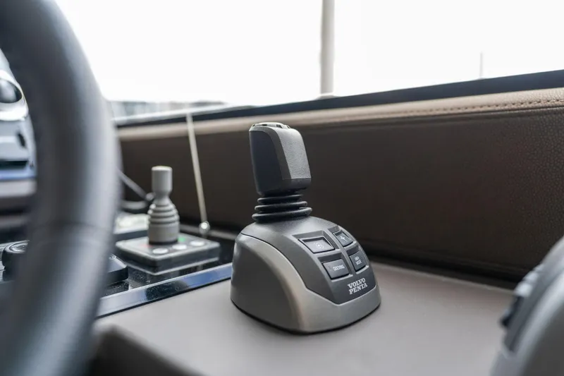 Slide: The Image of Control panel of a 2022 Prestige 520 yacht with joystick and buttons. - 35