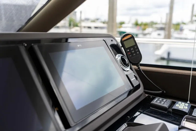 Slide: The Image of Control panel of a 2022 Prestige 520 yacht with navigation screens and communication device. - 37