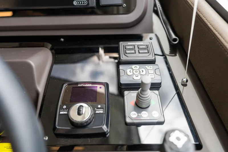 Slide: The Image of Control panel of a 2022 Prestige 520 yacht with navigation and joystick controls. - 39