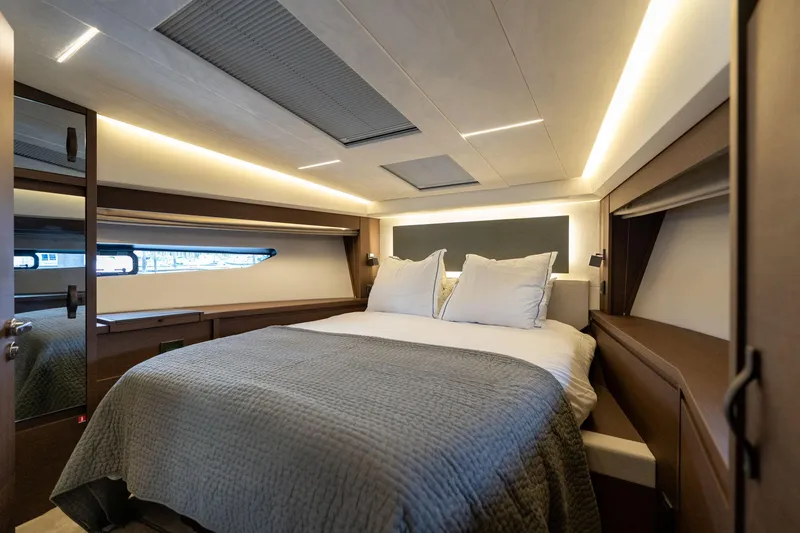 Slide: The Image of Luxurious bedroom interior of 2022 Prestige 520 yacht with modern lighting and cozy bedding. - 41