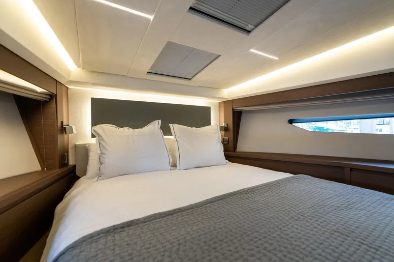 Slide: The Image of Luxurious bedroom interior of 2022 Prestige 520 yacht with modern lighting and cozy bedding. - 42