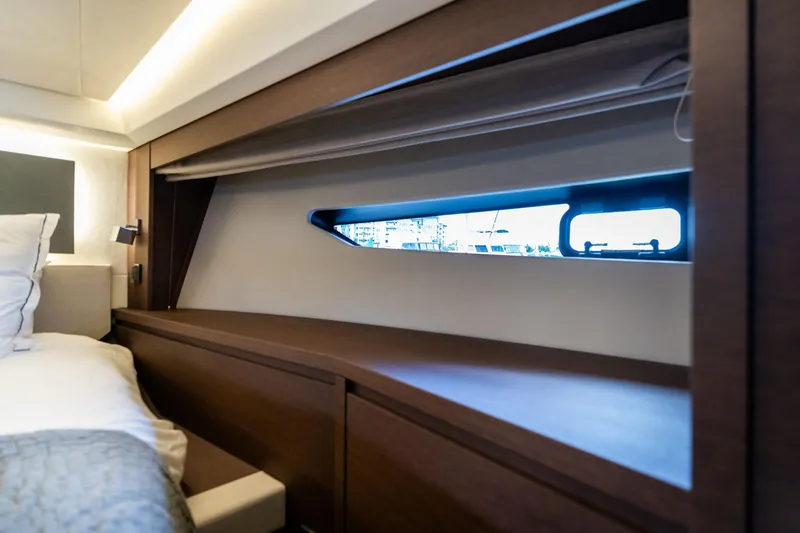 Slide: The Image of Luxurious interior of 2022 Prestige 520 yacht with sleek wood finish and window view. - 45