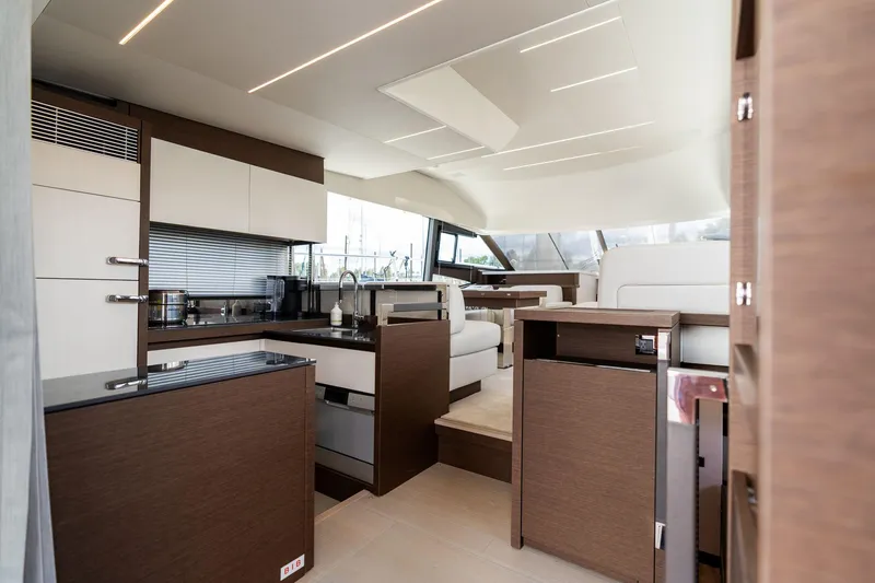 Slide: The Image of Luxurious interior of 2022 Prestige 520 yacht with modern kitchen and seating area. - 5