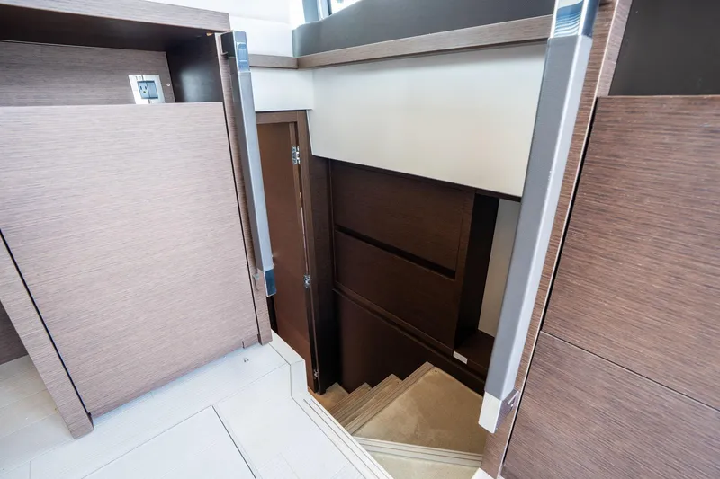 Slide: The Image of Interior stairs of 2022 Prestige 520 yacht with modern wood finish. - 7