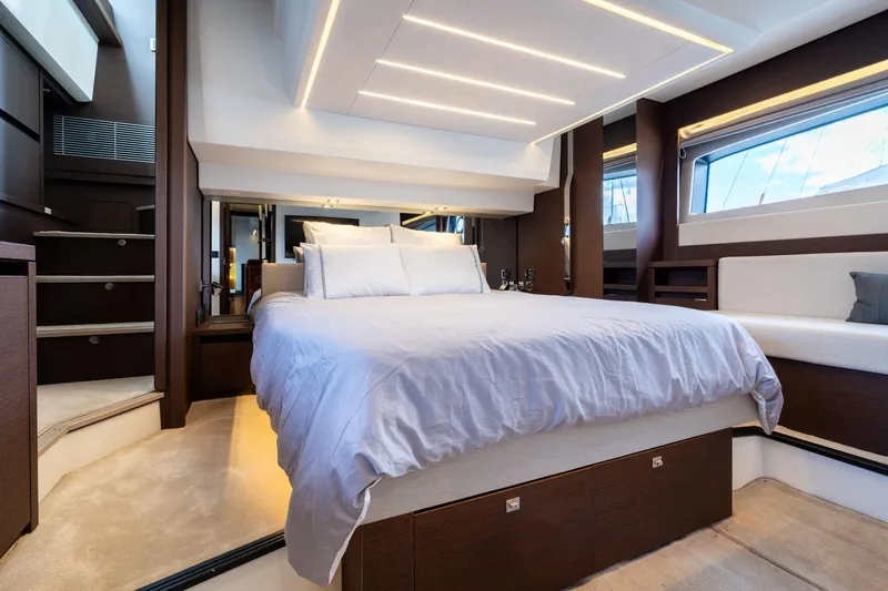 Slide: The Image of Luxurious bedroom interior of 2022 Prestige 520 yacht with modern design and ambient lighting. - 9