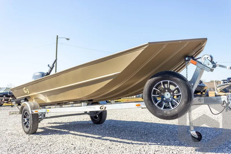 Slide: The Image of 2026 G3 Gator Tough 1652 VBW boat on trailer, displayed outdoors. - 13