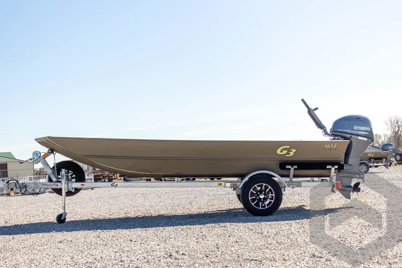 Slide: The Image of 2026 G3 Gator Tough 1652 VBW boat on trailer with Yamaha motor, outdoor setting. - 17