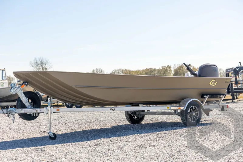 The Image of 2026 G3 Gator Tough 1860 VBW boat on trailer, parked outdoors. - 1